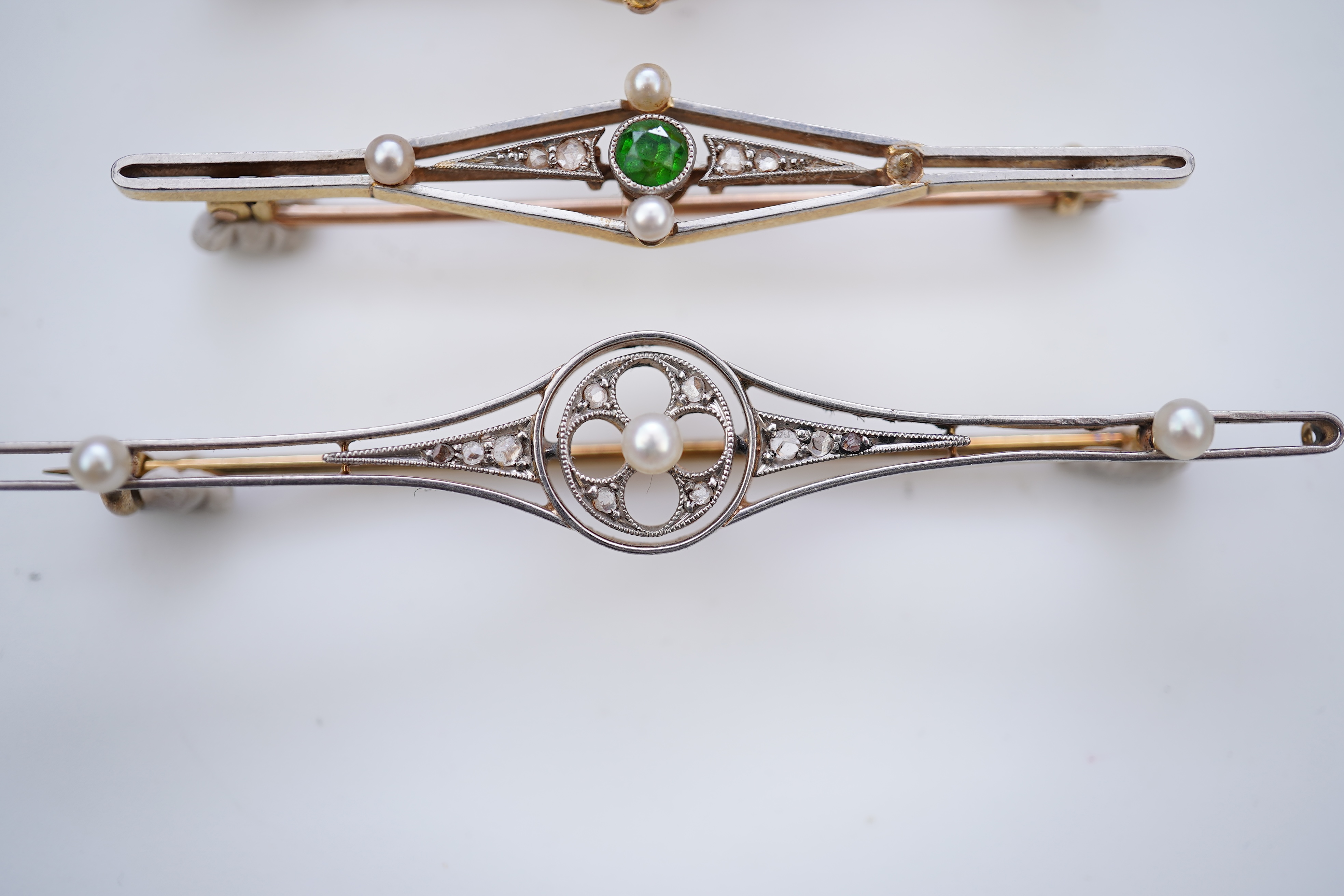 Four gold and gem-set bar brooches, early 20th century